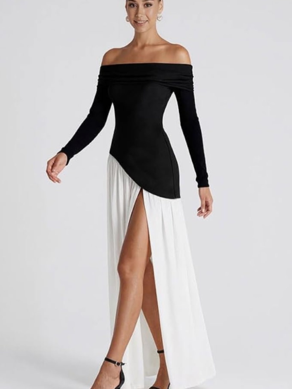 Chic off-shoulder dress a contrasting black waist panel and flowing white asy